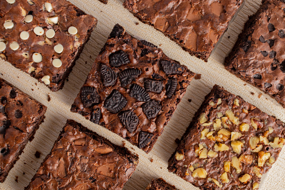 Assortment of different types of brownies, featuring cookies, chocolate chips, and even nuts