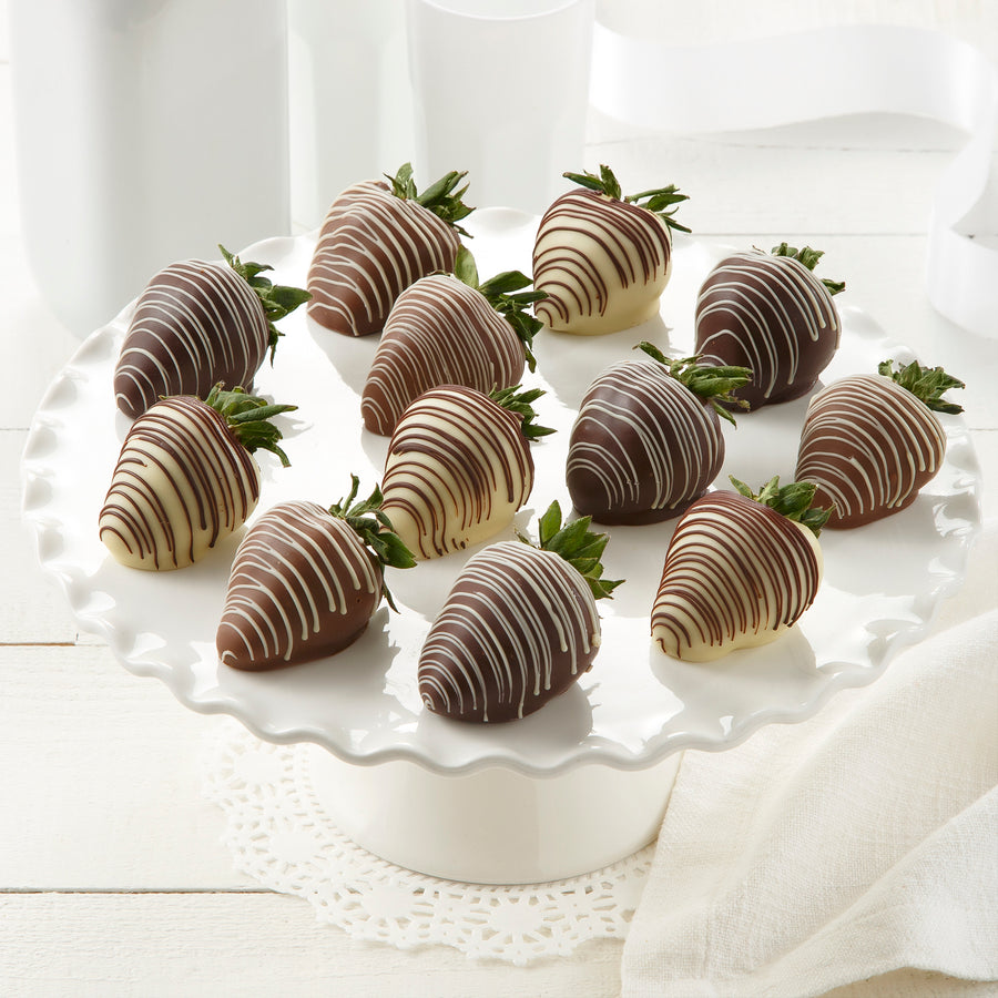 A dozen chocolate covered strawberries dipped and drizzled in dark, milk, and white chocolate.