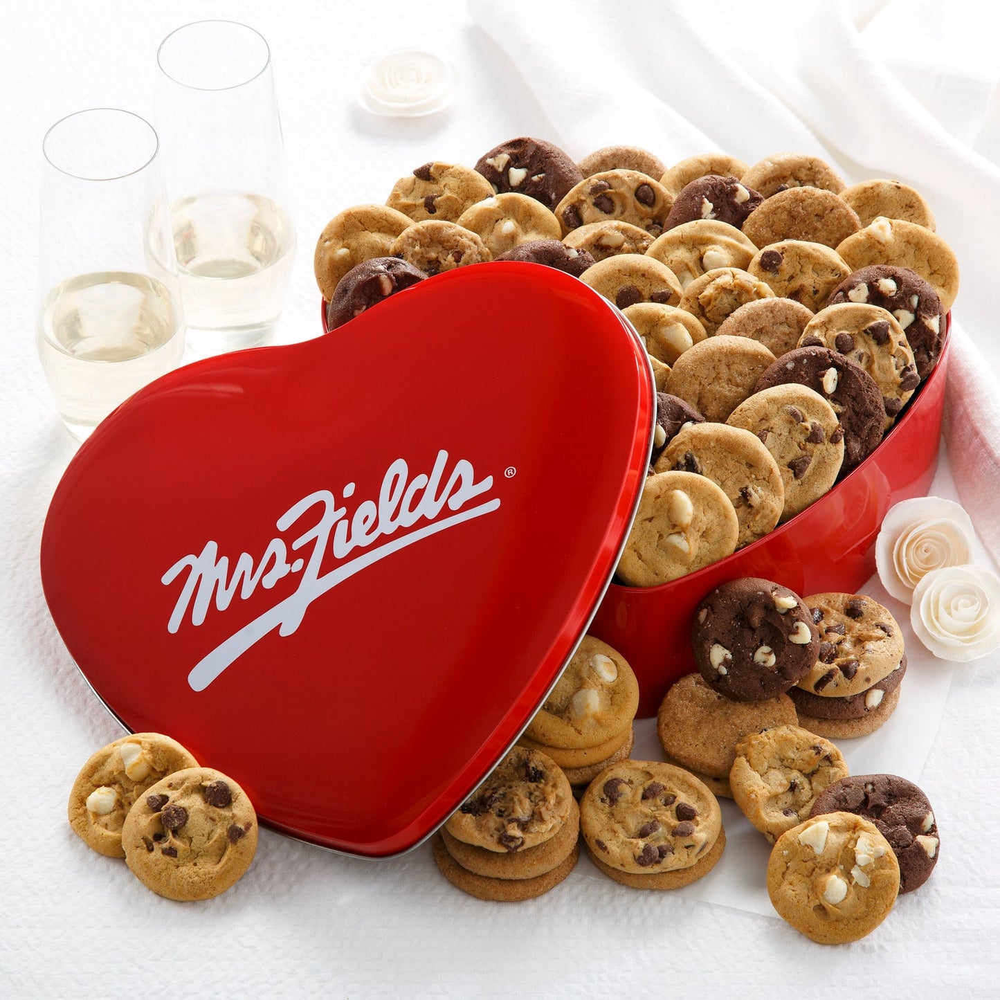 A heart shaped Mrs Fields red tin filled with an assortment of Nibblers