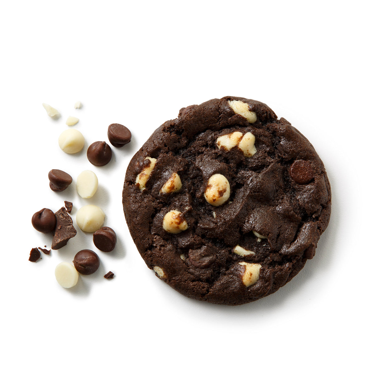 A round chocolate chip cookie with dark and white chocolate pieces, photographed on a clean white background with scattered chocolate chips and crumbs beside it.