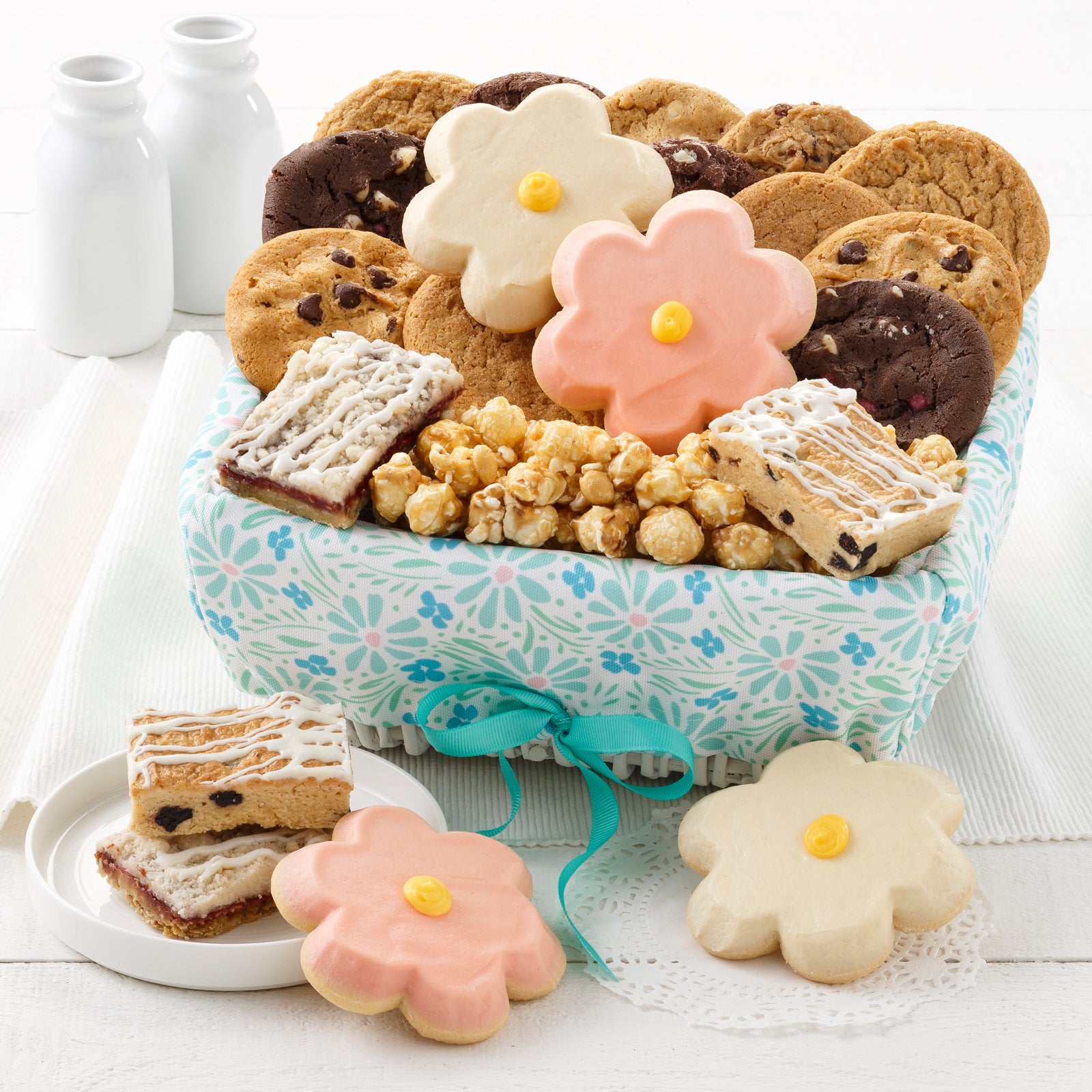 A spring themed gift basket filled with an assortment of original cookies, fruit bars, four frosted cookies, and popcorn