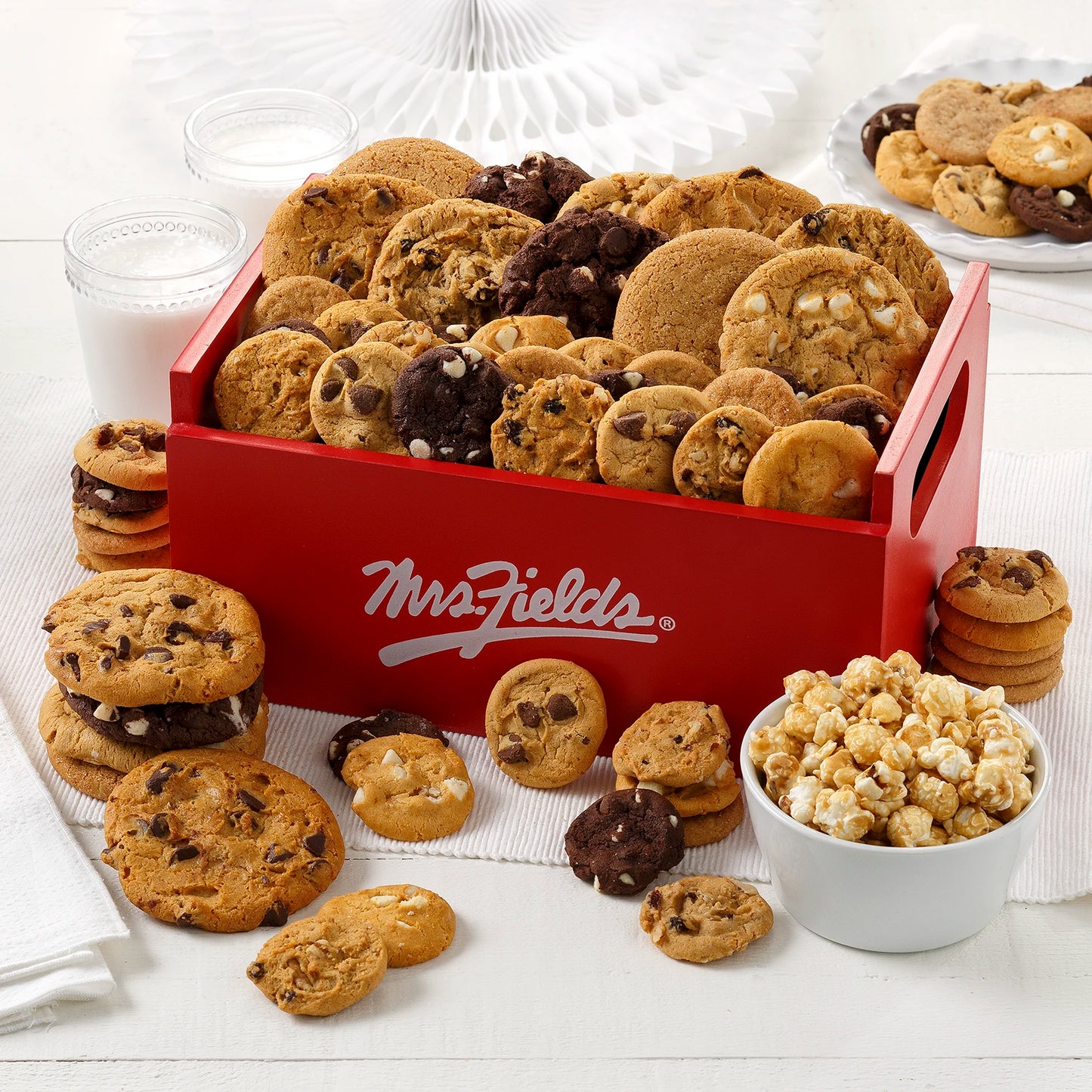 Red Mrs. Fields Crate filled with cookies, Nibblers® Bite-Sized Cookies and toffee nut popcorn