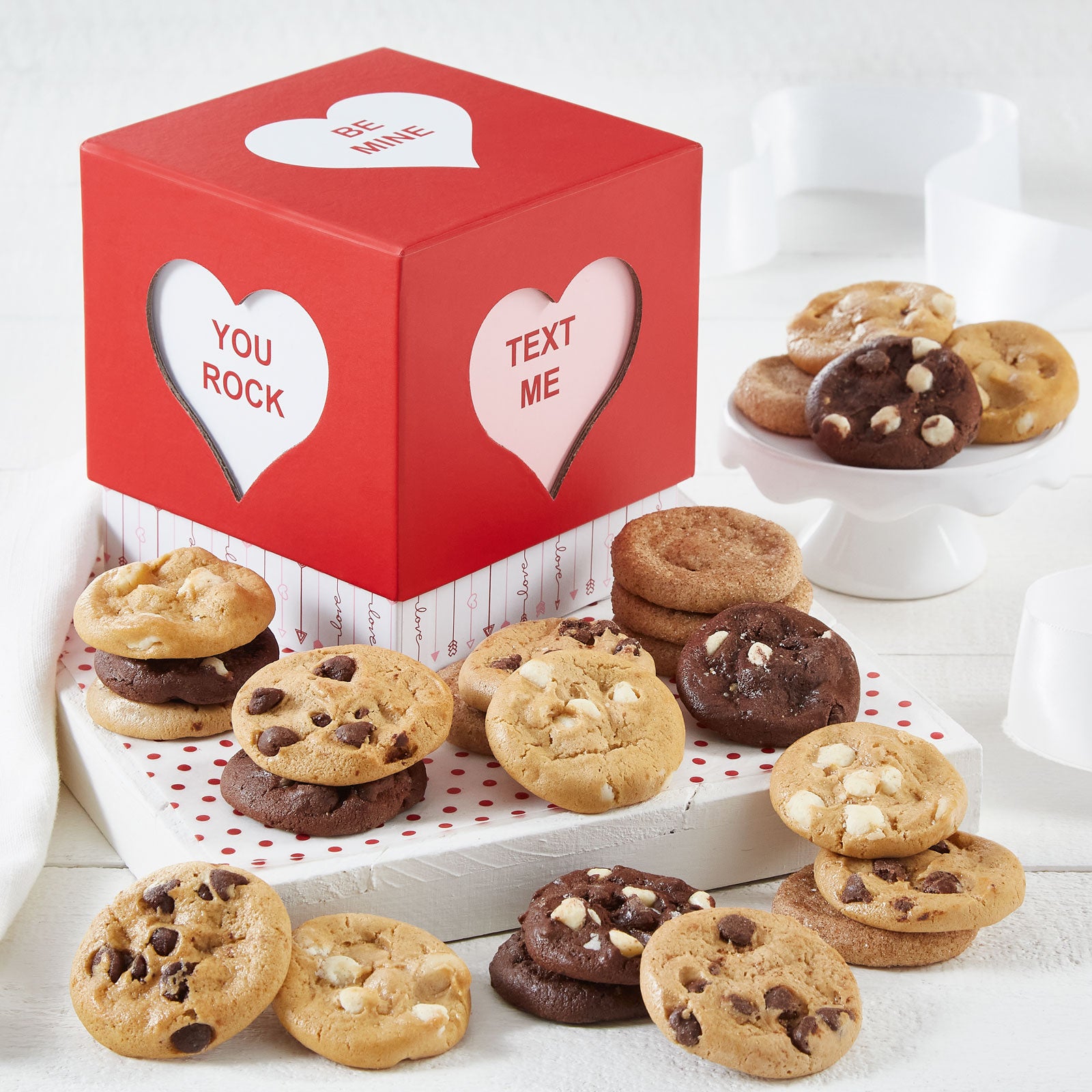 A conversation heart-themed mini gift box filled with an assortment of Nibblers.