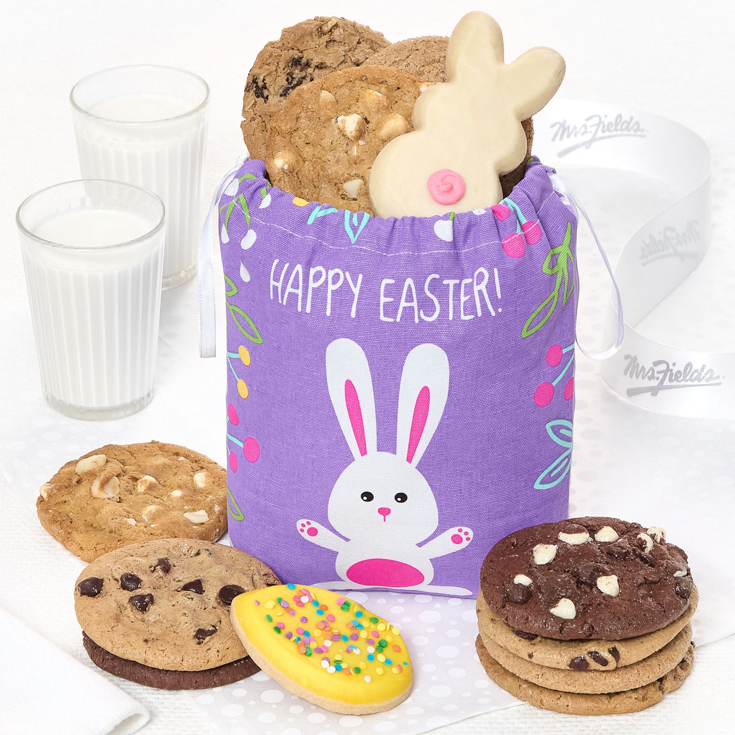 A purple Happy Easter tote filled with an assortment of original cookies, a frosted bunny cookie and a frosted egg cookie
