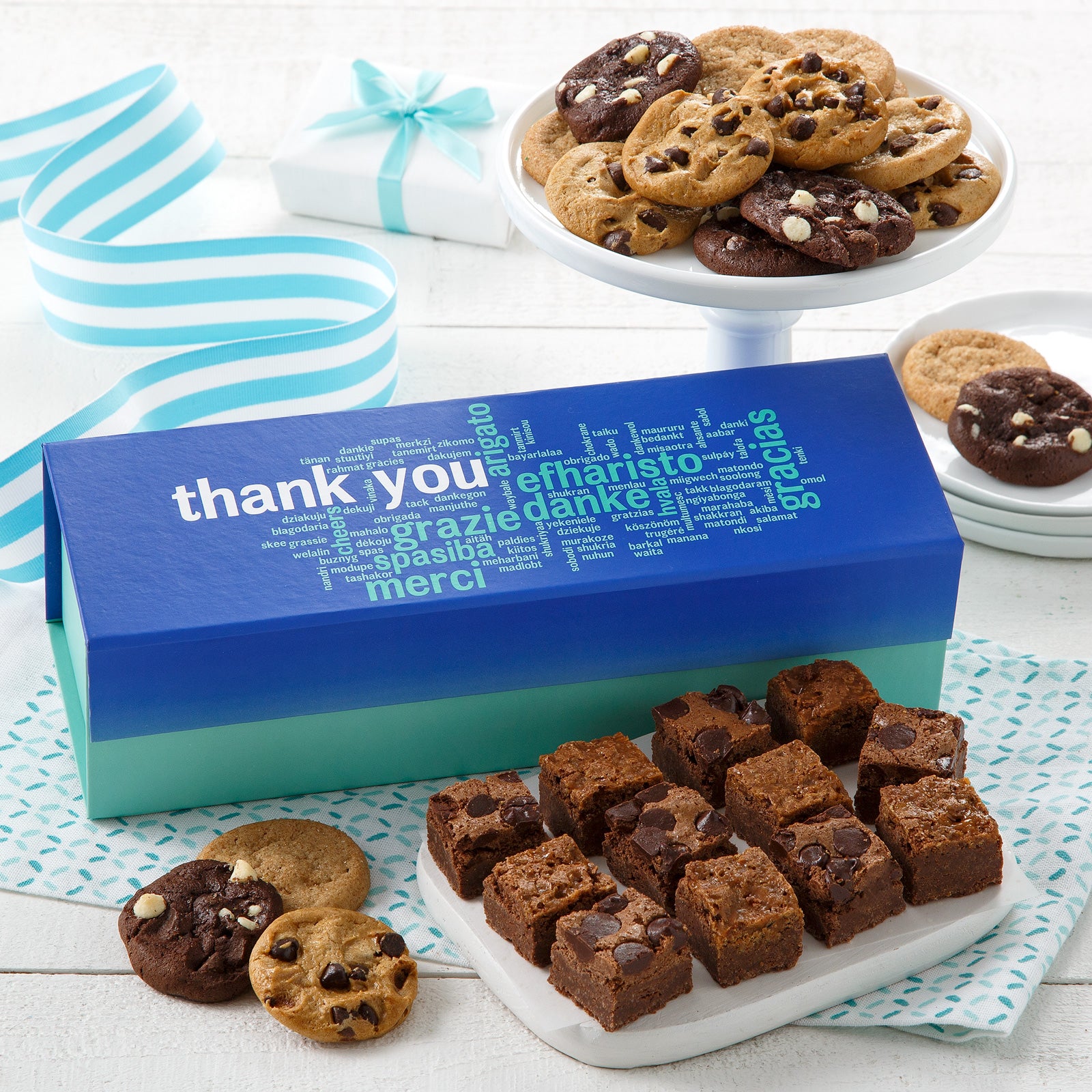 Appreciation gift box surrounded by an assortment of nibblers and brownie bites