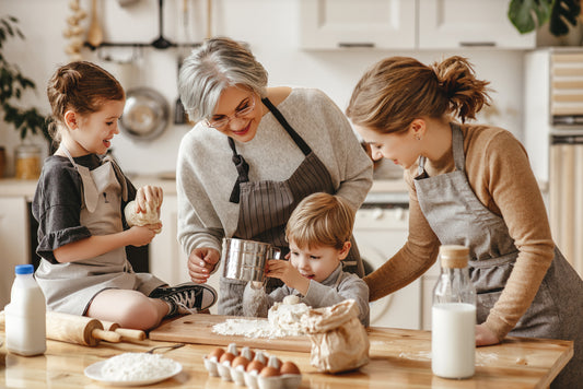 grandma and grandchildren baking cookies to celebrate National Cookie Day