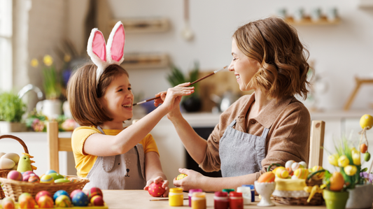Mother and daughter having fun while decorating Easter eggs 