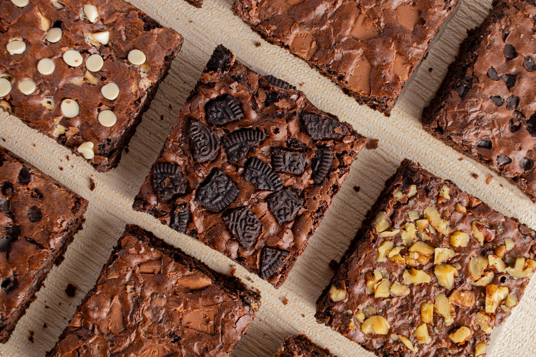 Assortment of different types of brownies, featuring cookies, chocolate chips, and even nuts 