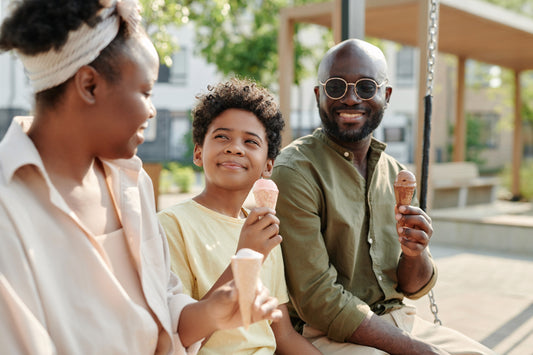 Happy Black family eating ice cream cones at an ice cream social