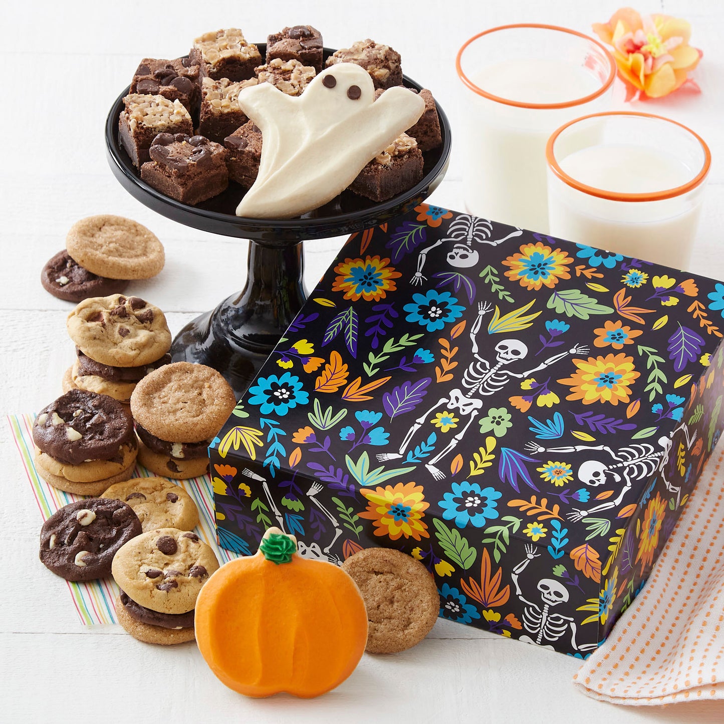Halloween skeleton themed gift box with an assortment of Nibblers®, brownie bites, a frosted ghost and pumpkin cookie