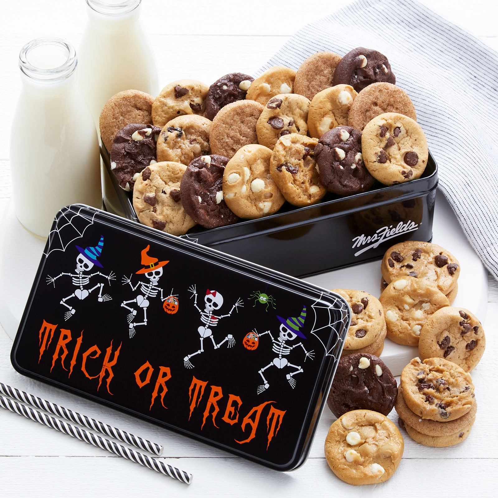 A halloween themed gift tin with a Trick or Treat sentiment with dancing skeletons on the front. This tin is filled with an assortment of Nibblers®