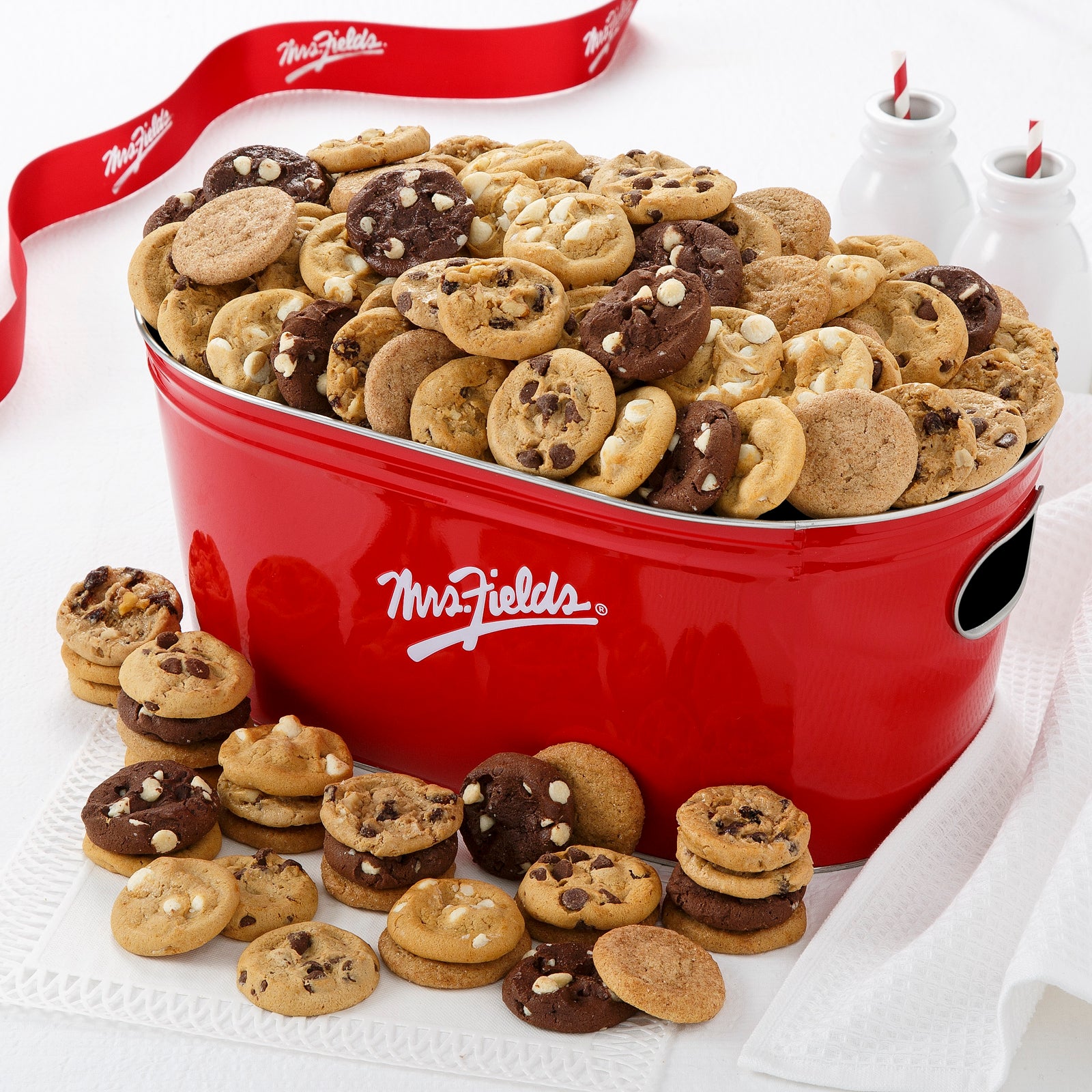 Signature red Mrs. Fields tub filled with an assortment of nibblers