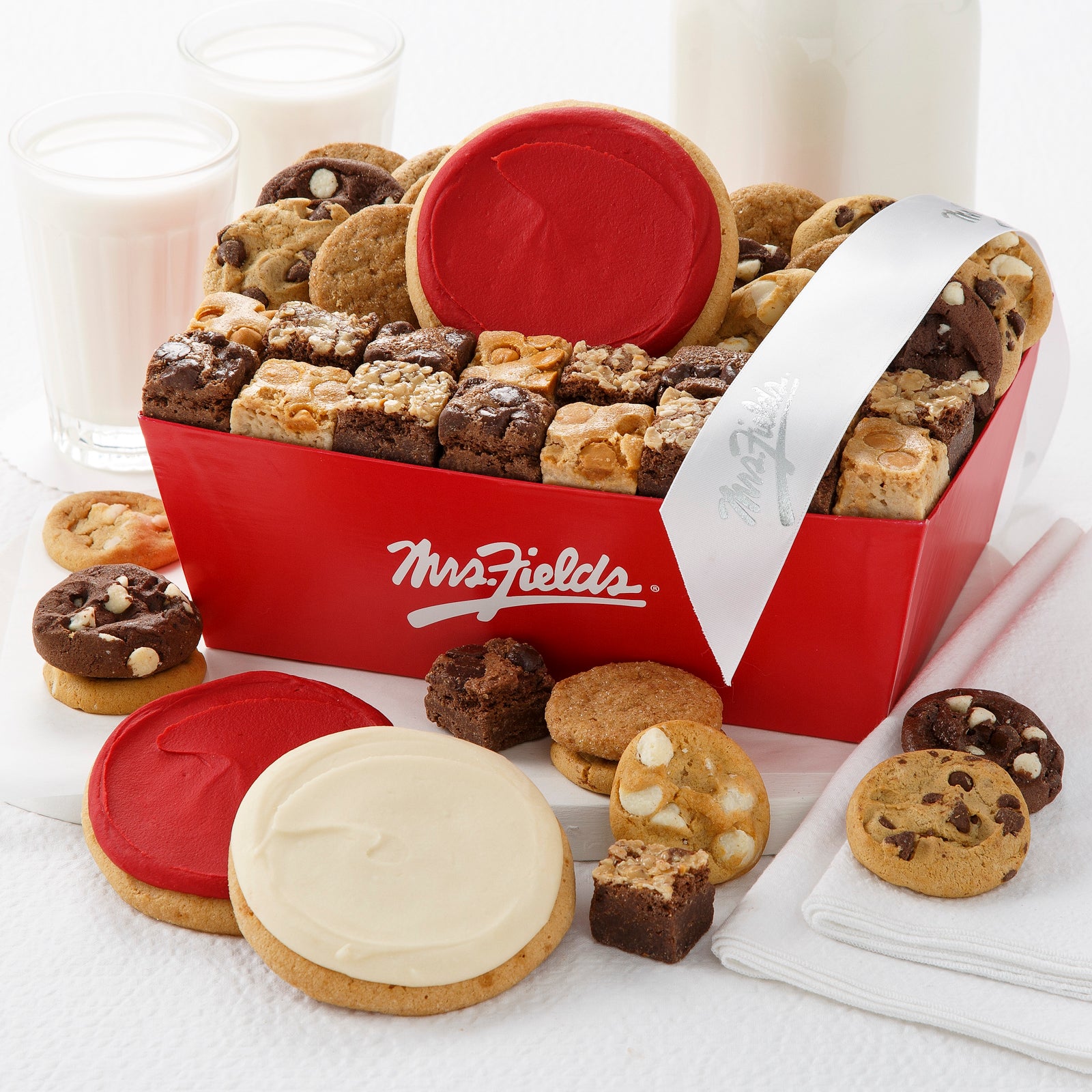 Red Mrs. Fields gift crate filled with an assortment of nibblers, brownie bites, and frosted cookies