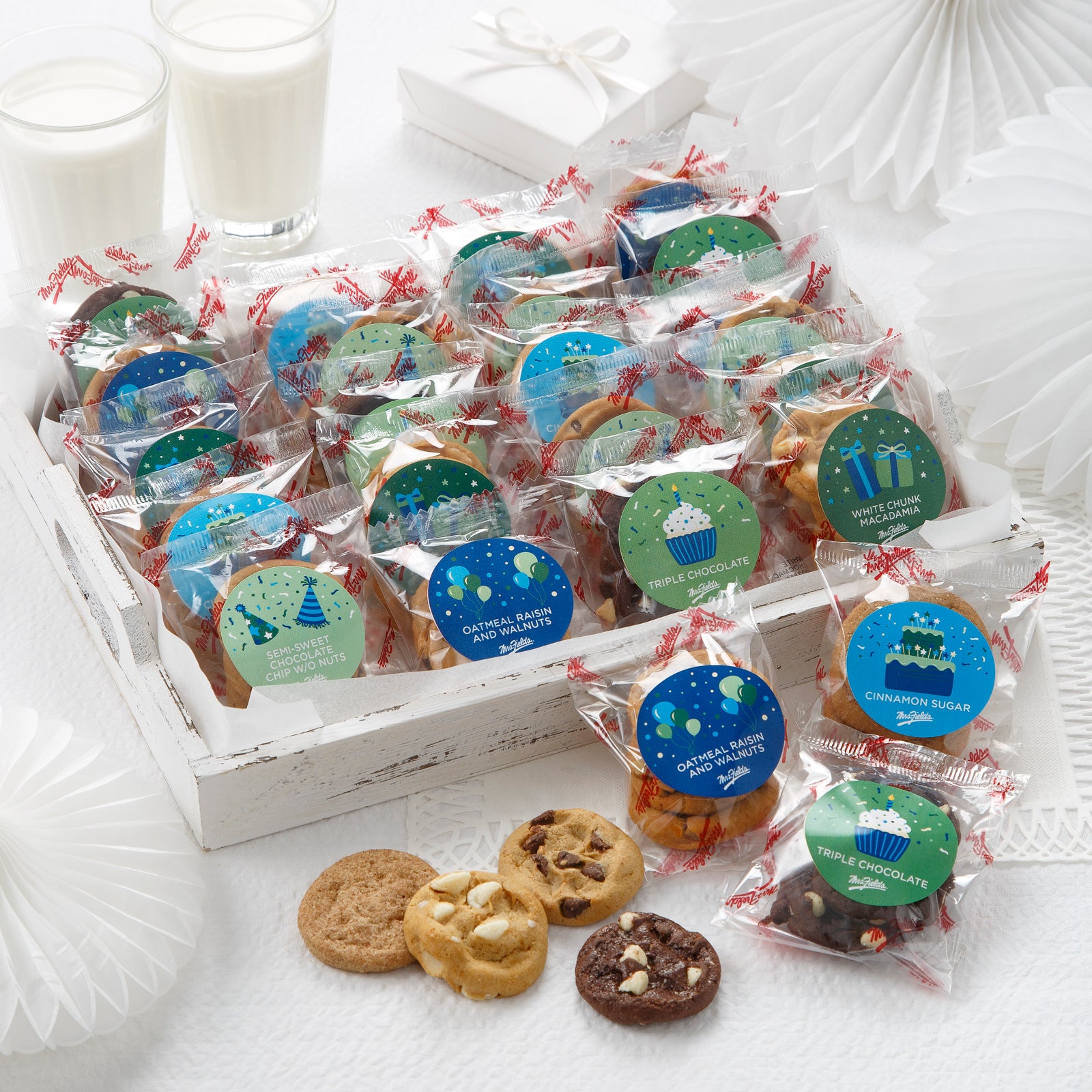 An assortment of packaged nibblers with birthday themed stickers on each package