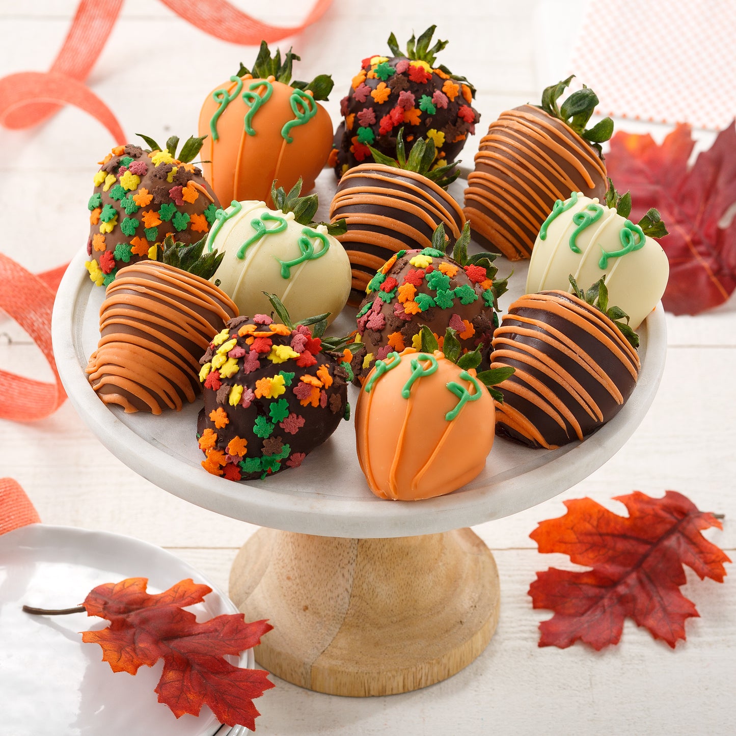 An assortment of Fall themed chocolate covered strawberries