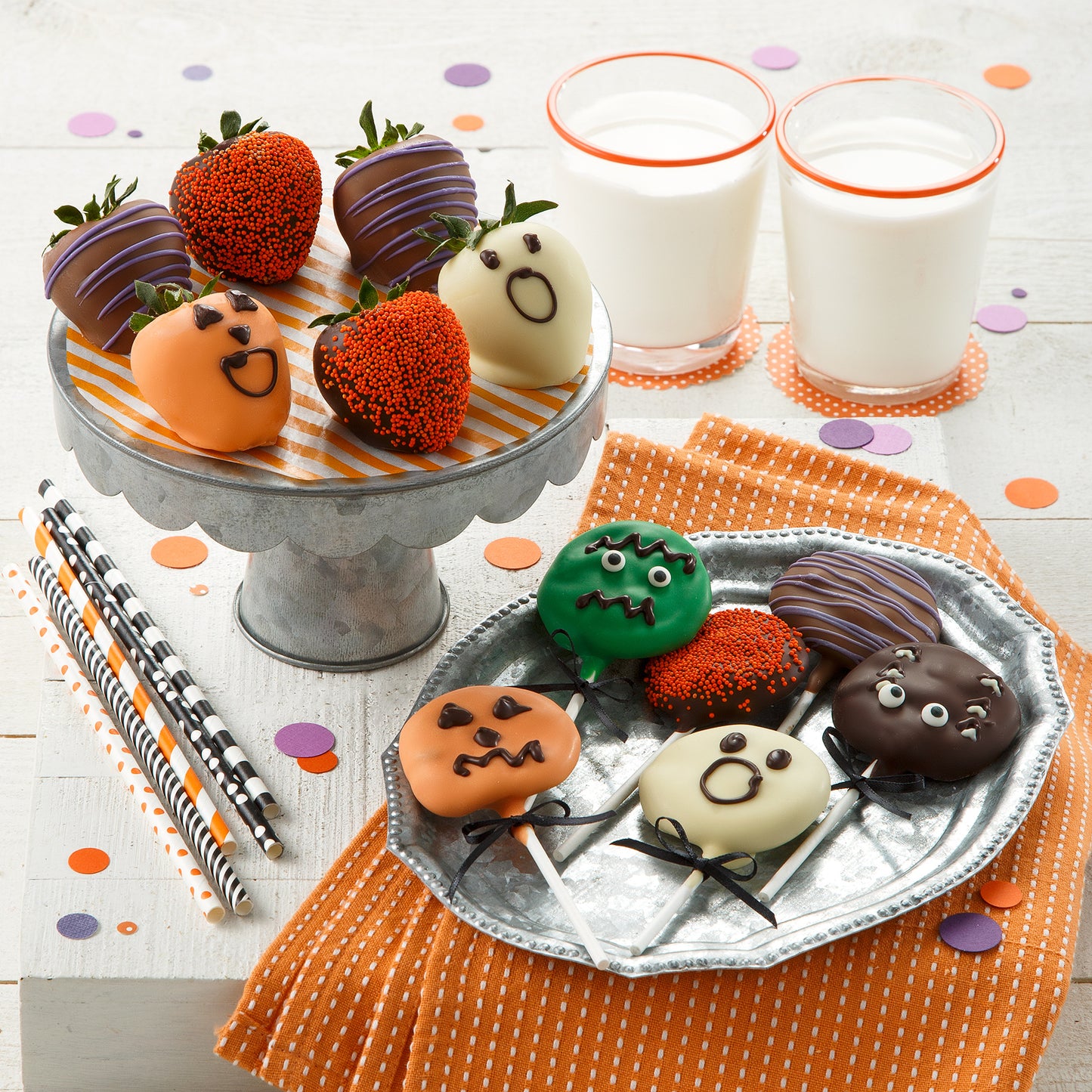 Halloween themed chocolate covered strawberries and an assortment of Halloween themed chocolate covered Nibbler® pops
