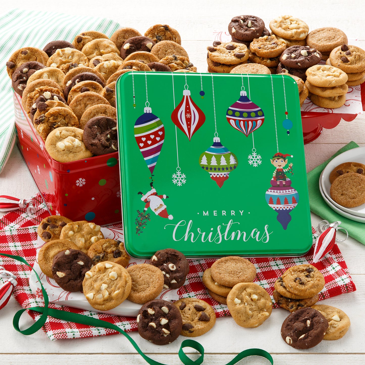 A red and green Merry Christmas gift tin decorated with Christmas ornaments and filled with an assortment of Nibblers®