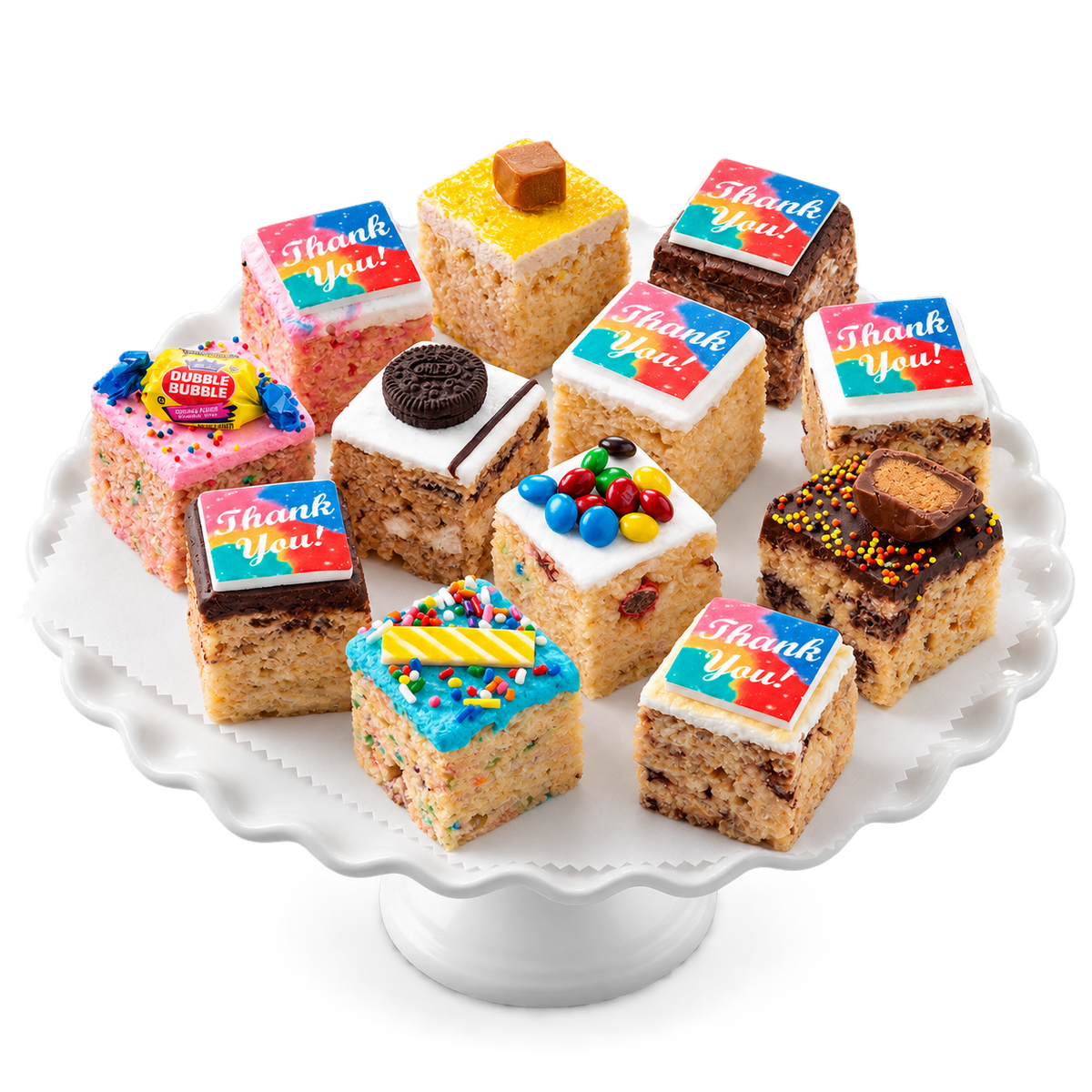 A set of mini chocolate chip cookie cups decorated with colorful frosting and candy, each topped with a 'Thank You!' card, arranged on a white scalloped cake stand with a white gift box and glass of milk in the background.