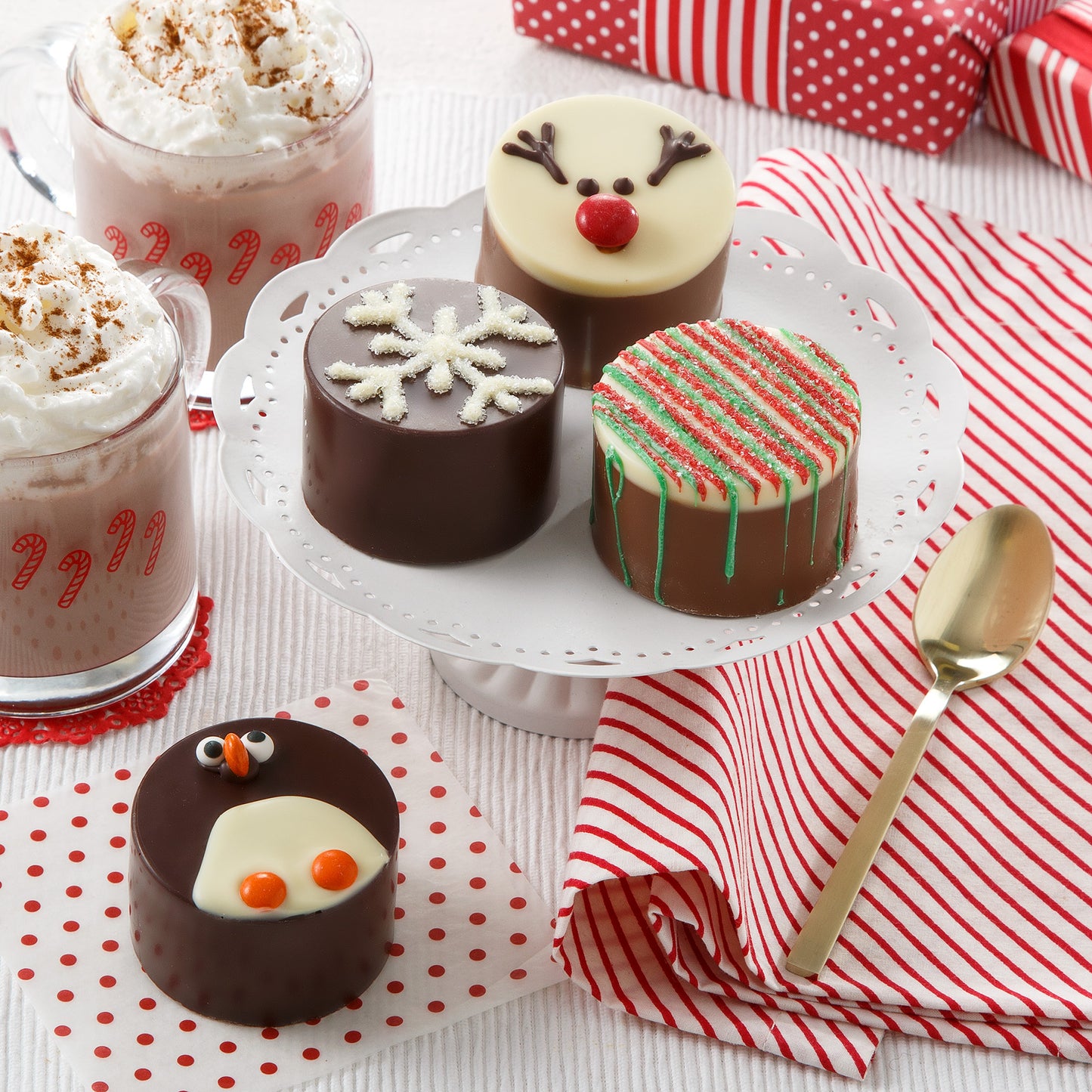 Four holiday decorated cocoa bombs