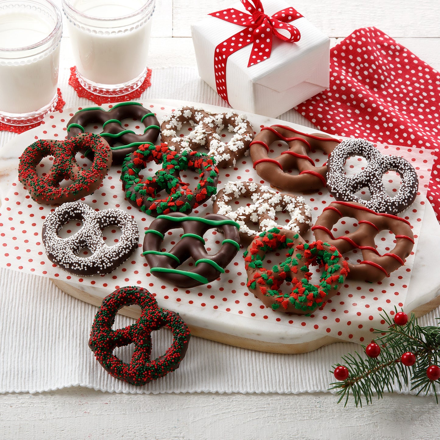Twelve holiday-decorated chocolate-decorated pretzels
