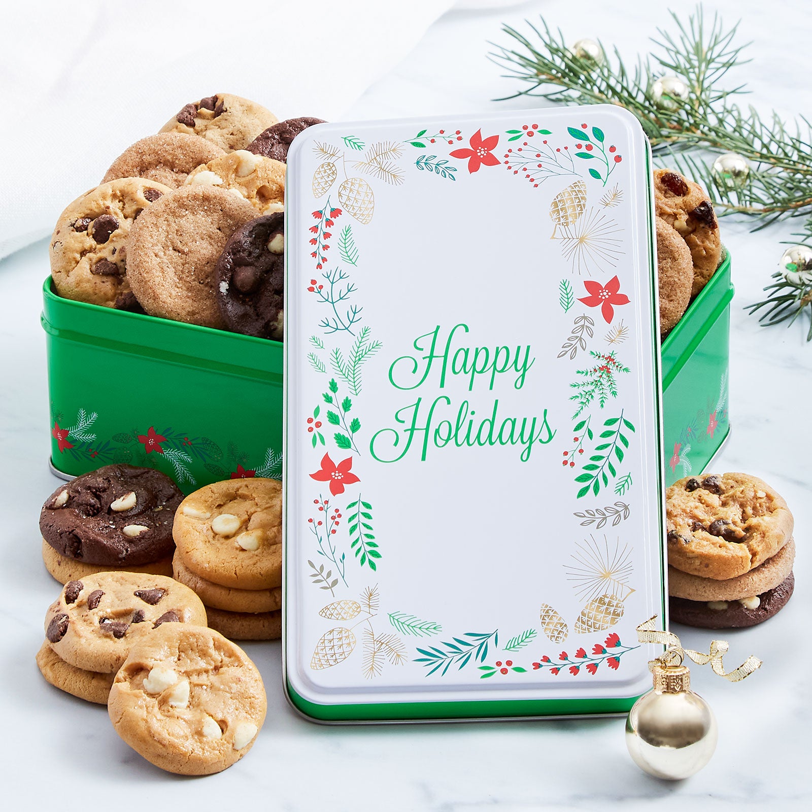 A Happy Holidays tin decorated with a wreath and filled with an assortment of Nibblers®