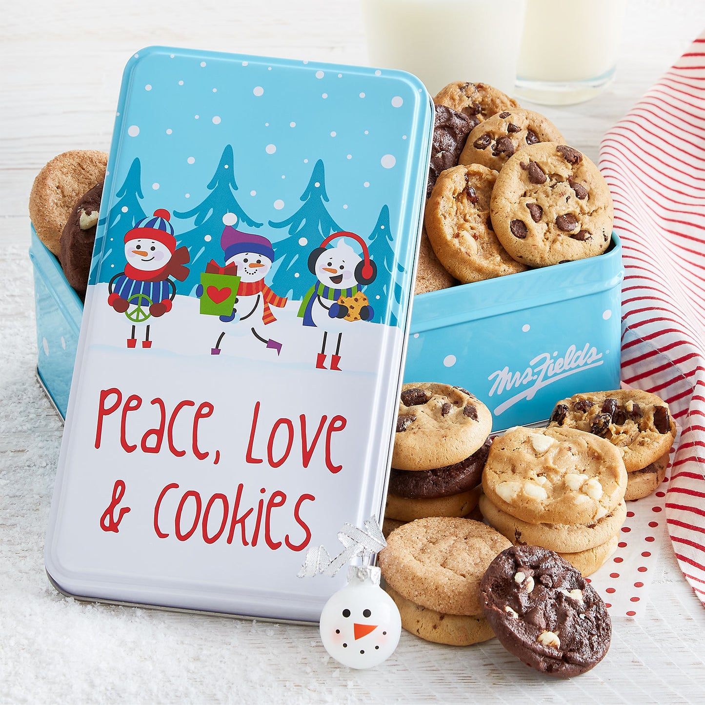 Peace, Love and Cookies sentiment on a gift tin with snowman friends as decorations. This tin is filled with an assortment of Nibblers®