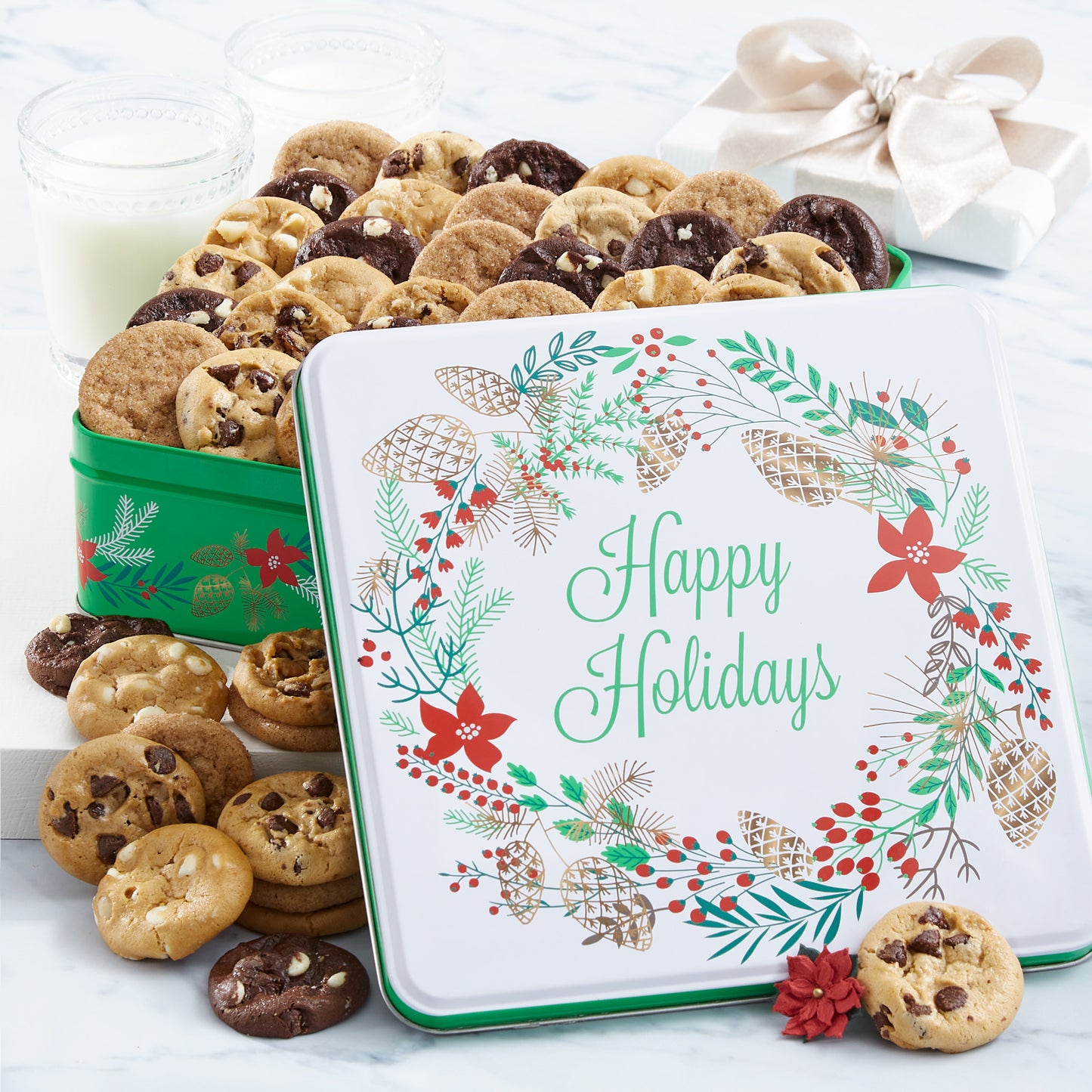 A green, red, and white Happy Holidays gift tin with the sentiment surrounded by a holiday wreath. This tin is filled with an assortment of Nibblers®
