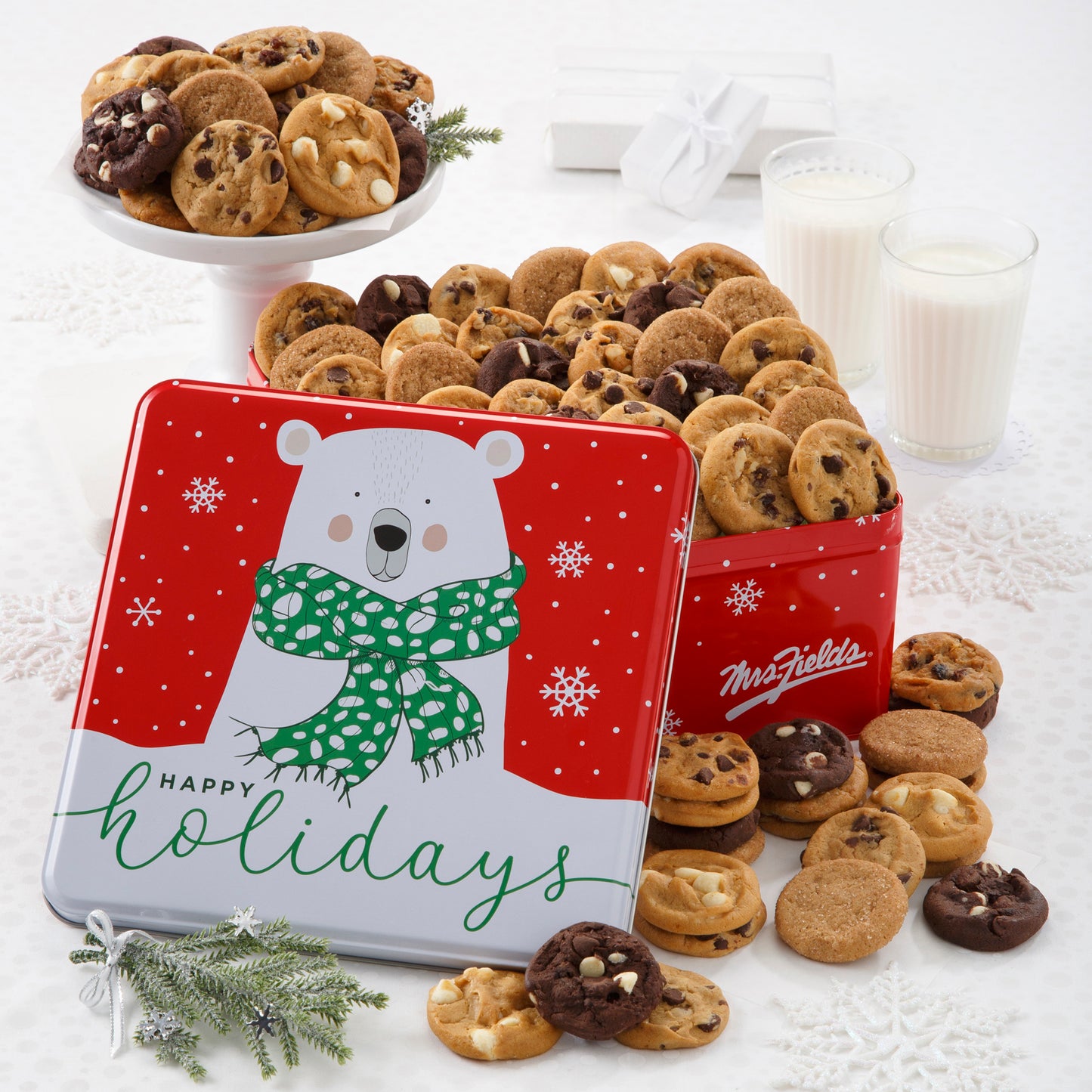 A Happy Holidays tin decorated with a polar bear filled with an assortment of Nibblers®.