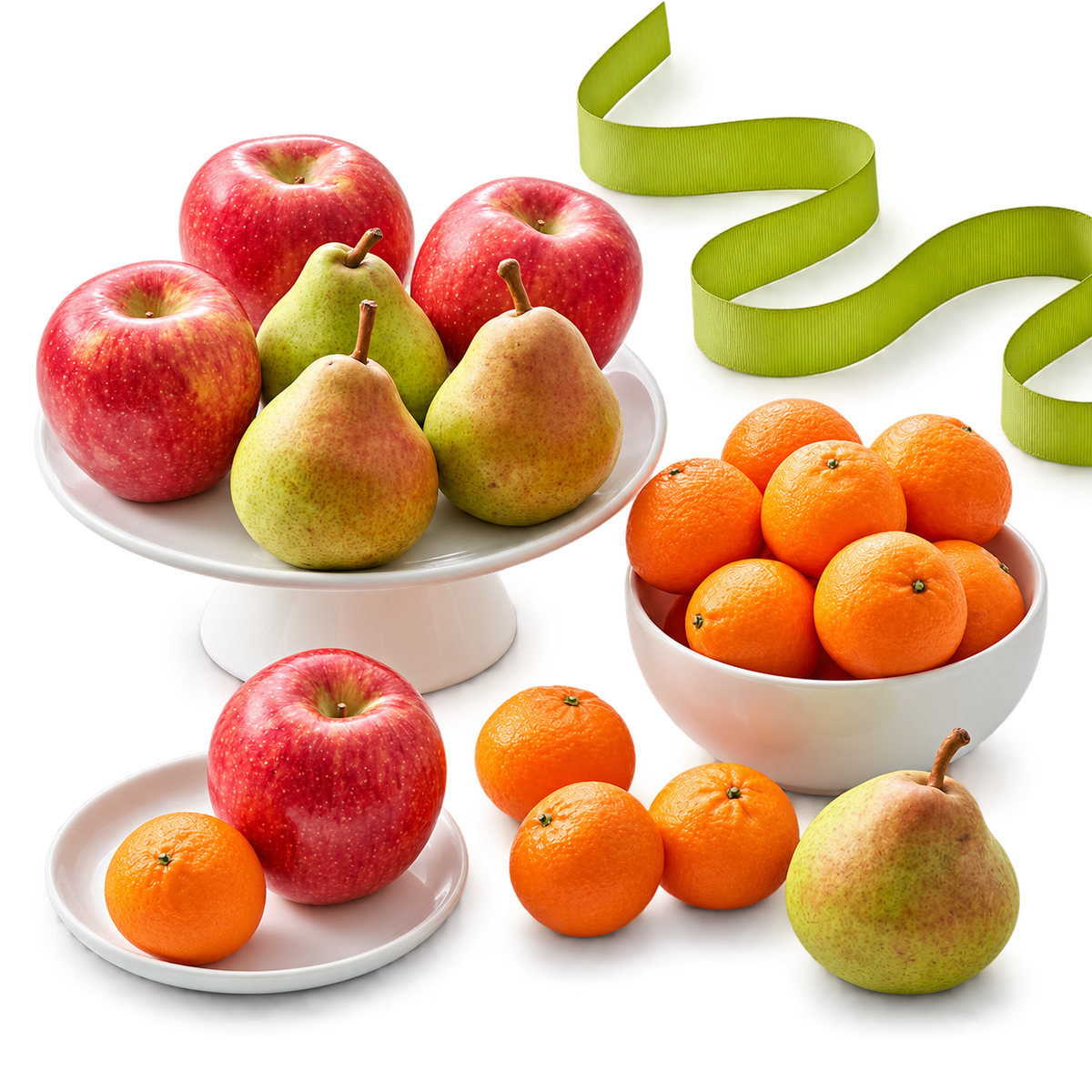 A styled fruit arrangement on a white surface, featuring red apples, green and yellow pears, and oranges in white bowls and plates, with a bright green ribbon in the background.