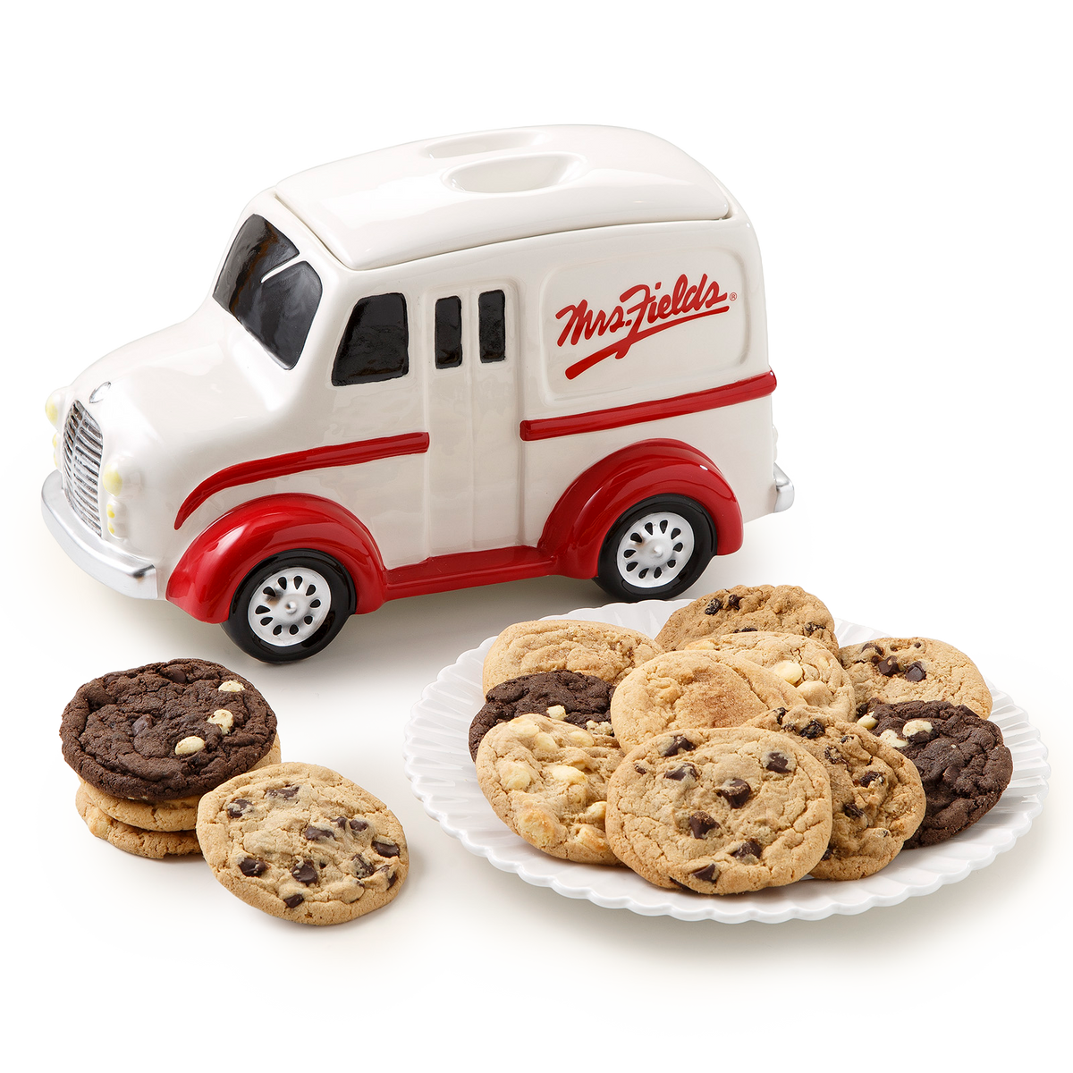A white and red Mrs. Fields cookie truck ceramic container shown with assorted chocolate chip cookies on a white plate and a few cookies beside it, on a clean white background.