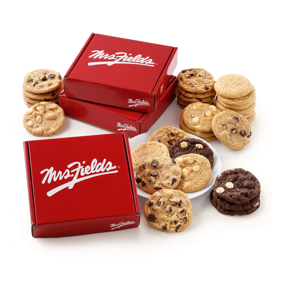 Two red Mrs. Fields cookie boxes surrounded by assorted cookies on a white background, including chocolate chip cookies, oatmeal cookies, and chocolate chip cookies with white chocolate chunks.