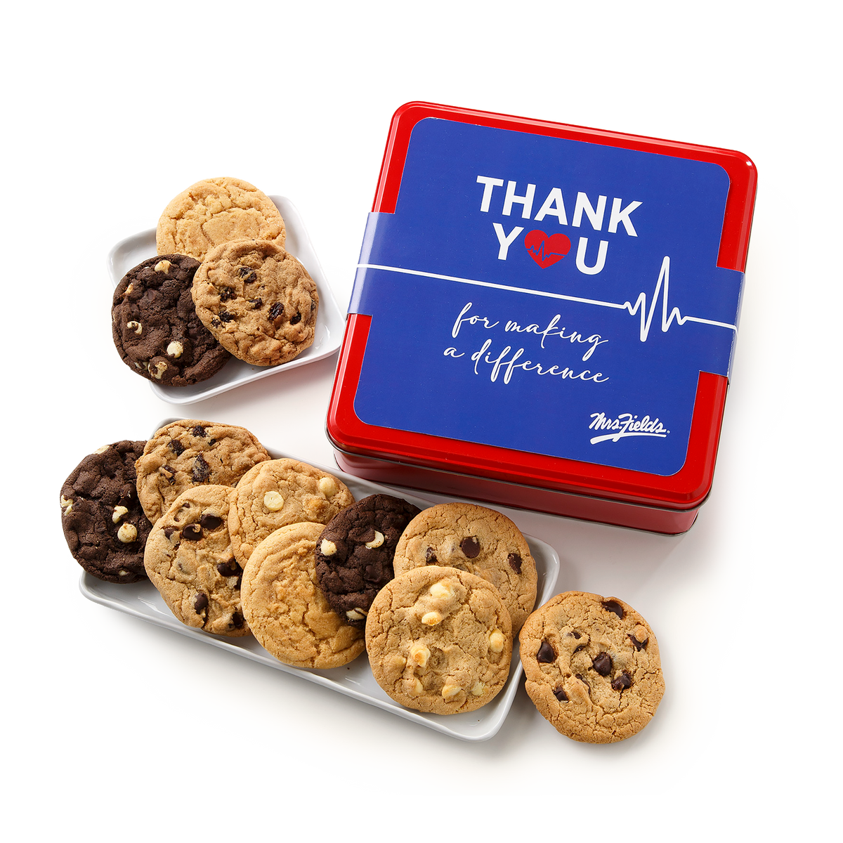 A red and blue cookie tin with a blue lid reading 'THANK YOU for making a difference' and a heartbeat line, shown on a white background with assorted chocolate chip cookies on white trays.