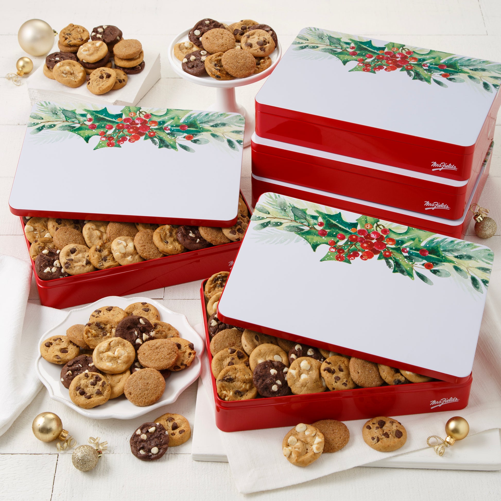 Five Holly gift tins with an assortment of Nibblers®