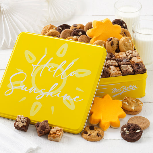 Yellow Hello Sunshine gift tin filled with an assortment of nibblers, brownie bites, and frosted sun cookies