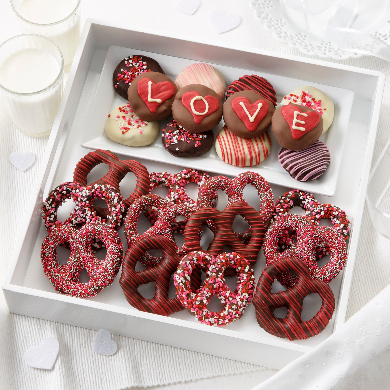 A dozen Valentine's Day themed chocolate covered nibblers and pretzels.