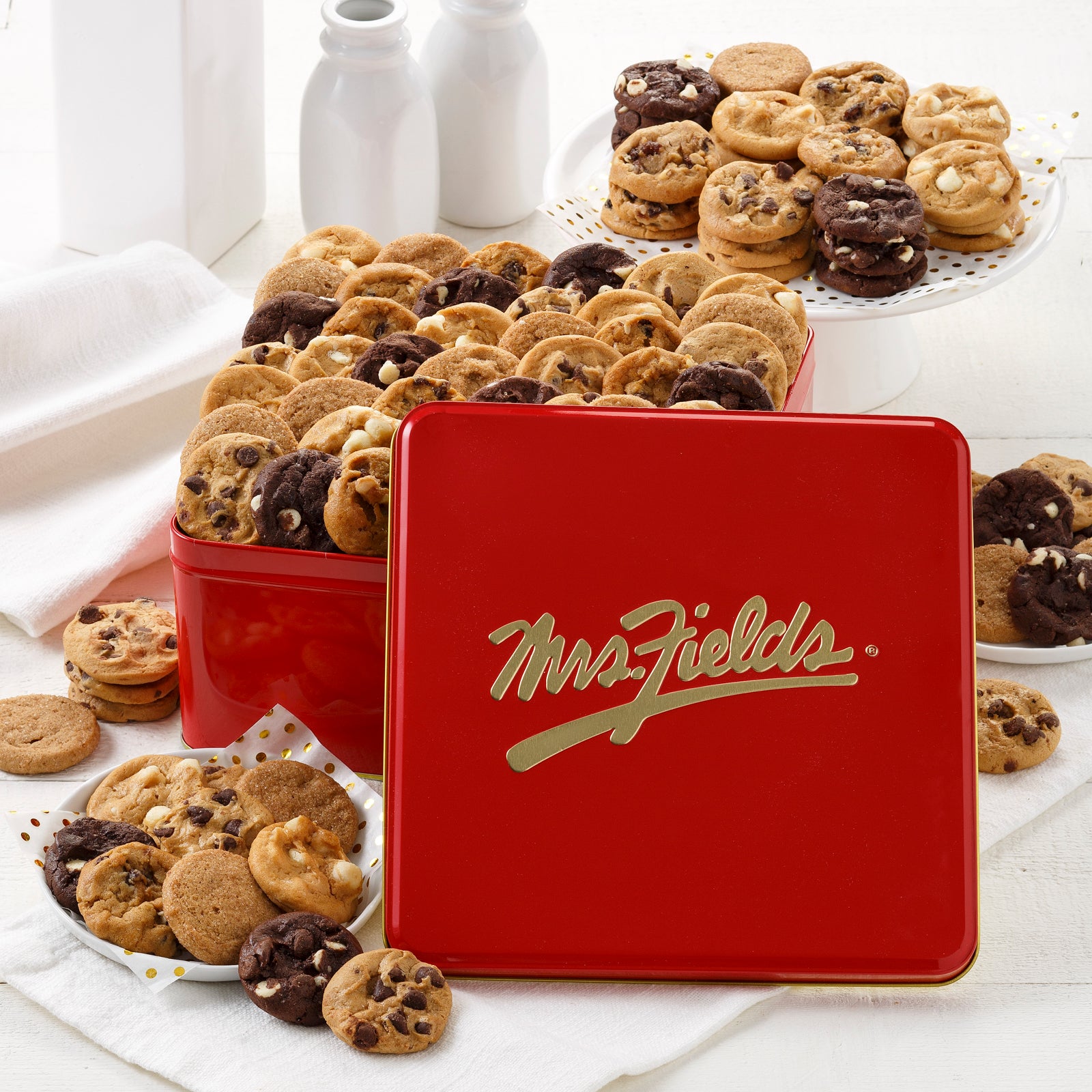 A red and gold signature 90 Nibblers tin filled with an assortment of Nibblers®