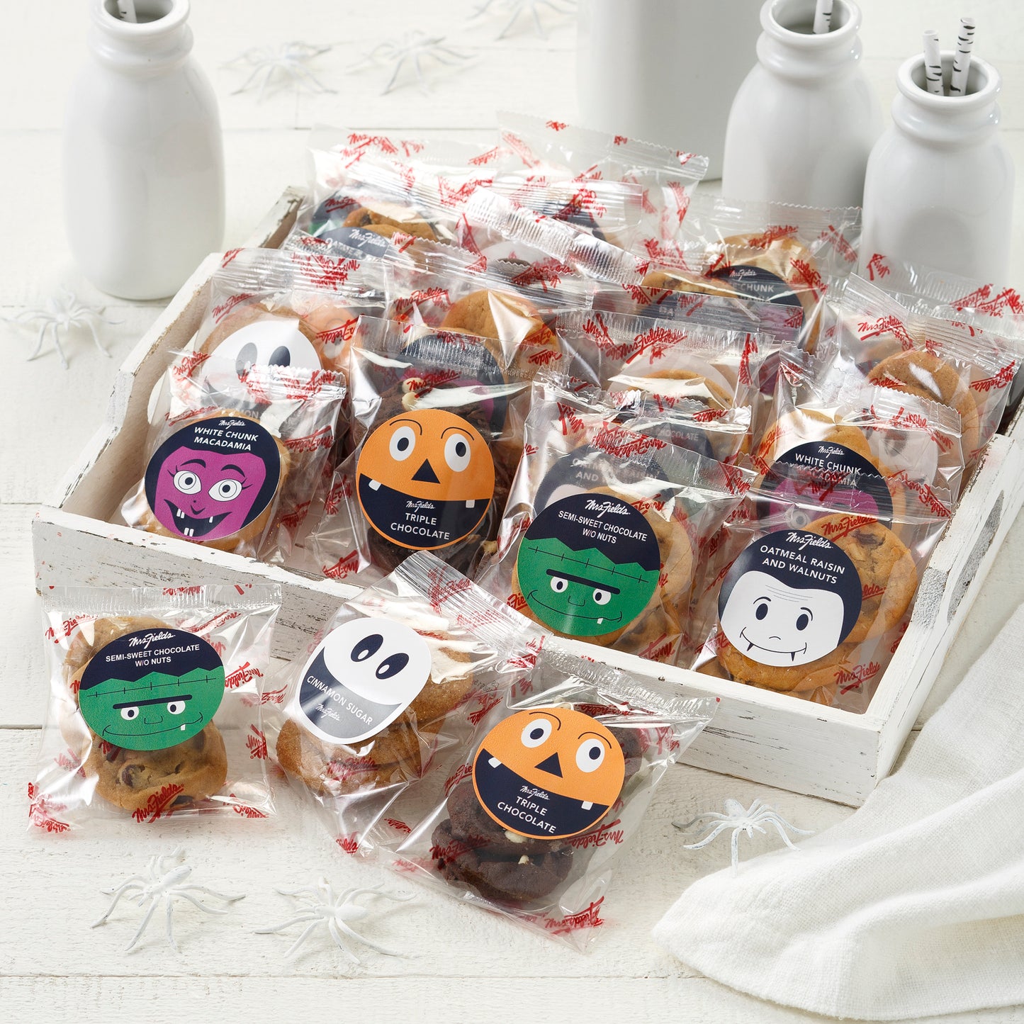 An assortment of packaged Nibblers® with Halloween themed stickers