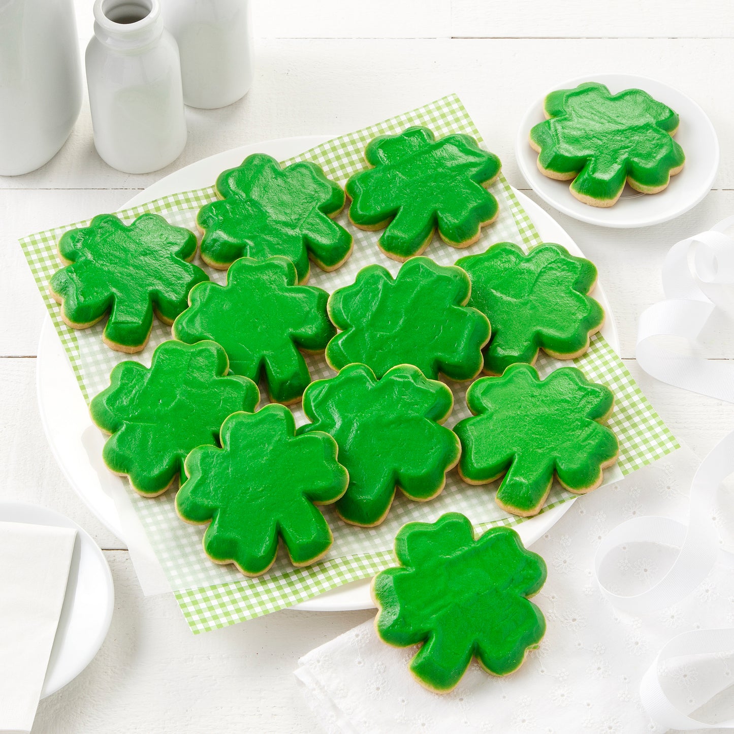 A dozen green frosted shamrock cookies