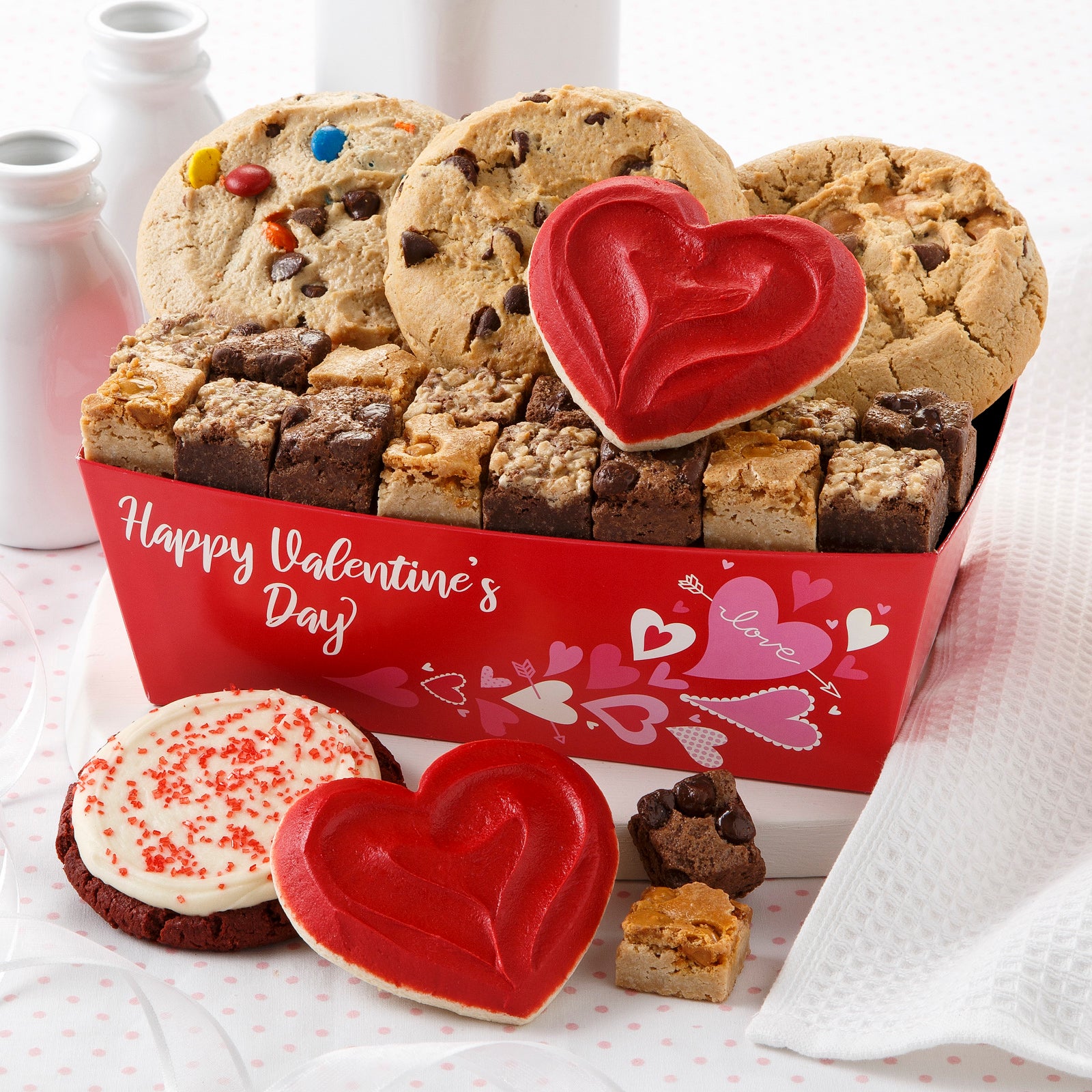 A Happy Valentine's Day gift crate filled with mega cookies, brownie bites, two frosted heart cookies and one red velvet frosted cookie