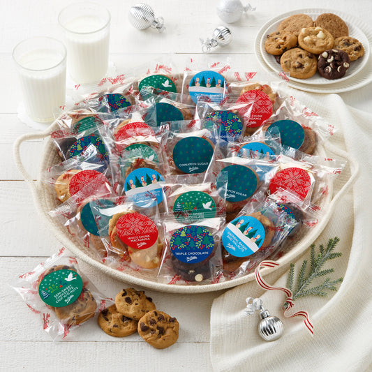 An assortment of packaged Nibblers® that each flavor has a festive holiday sticker