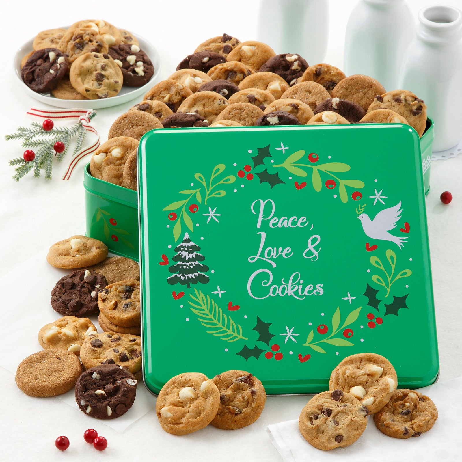 Green Peace, Love, & Cookies tin decorated with a holiday wreath and filled with an assortment of Nibblers®