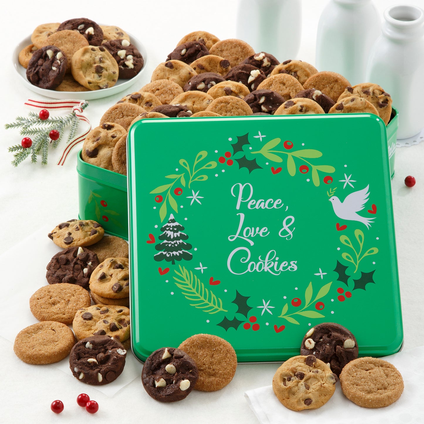 Green Peace, Love, & Cookies tin decorated with a wreath and filled with an assortment of nut-free Nibblers®