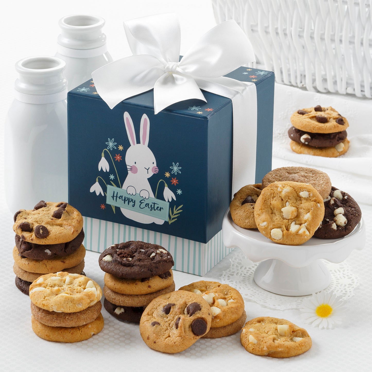 A dark blue Easter themed mini gift box surrounded with an assortment of nibblers
