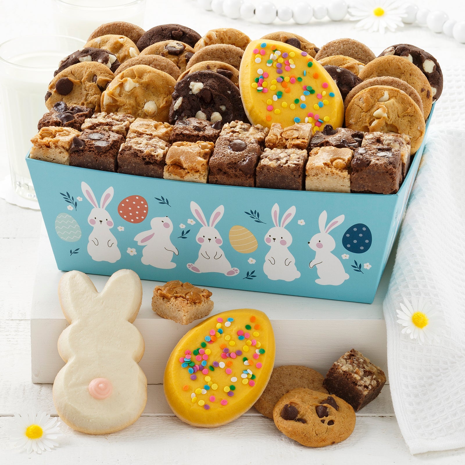 A light blue easter crate decorated with bunnies and eggs and filled with an assortment 