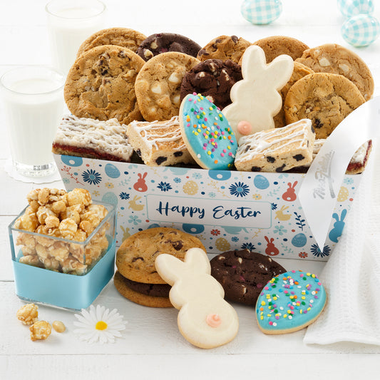 An Easter themed gift crate filled with an assortment of original cookies, fruit bars, frosted egg cookies, frosted bunny cookies, and popcorn