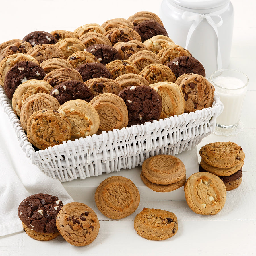 A white wicker basket filled with an assortment of original Mrs. Fields cookies.