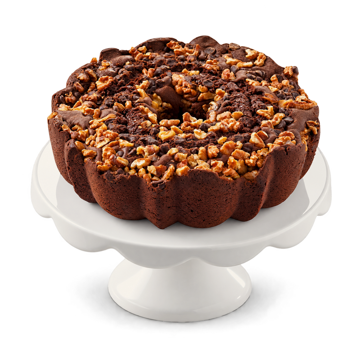 A chocolate bundt cake topped with chopped nuts and chocolate drizzle, displayed on a white scalloped cake stand against a clean white background.