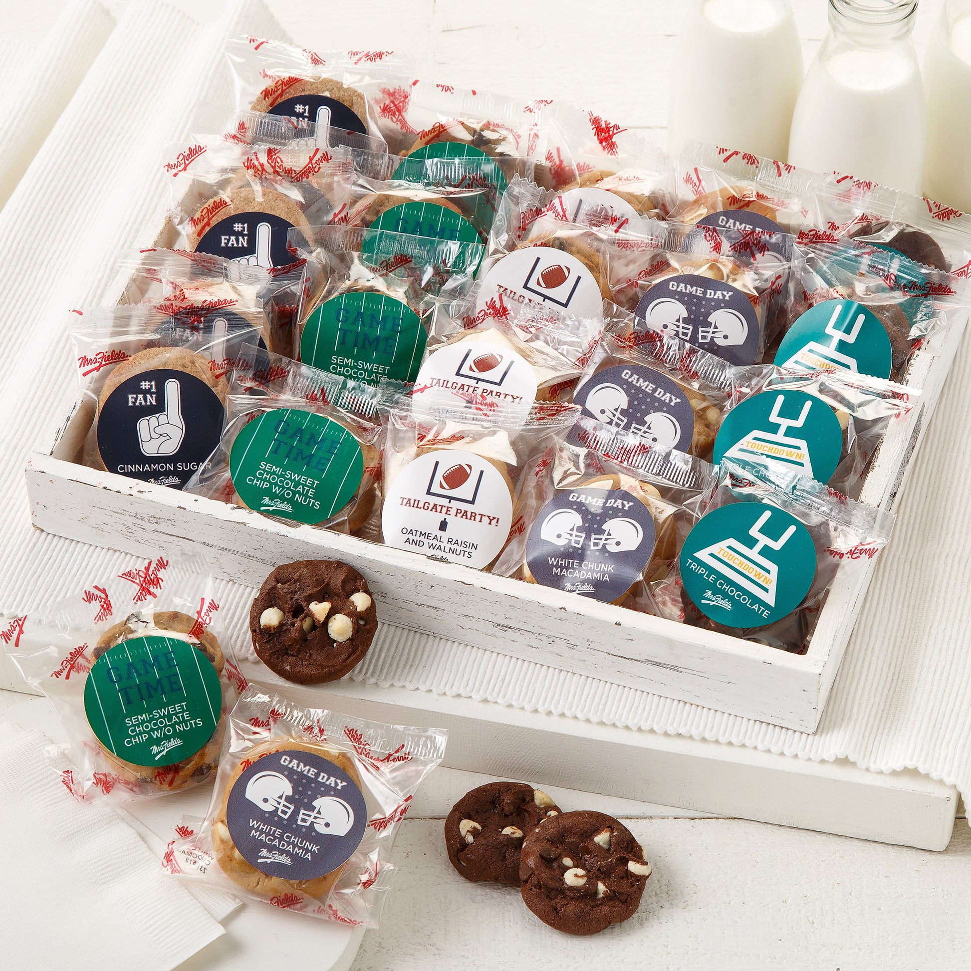 An assortment of packaged nibblers with football themed stickers on the packages