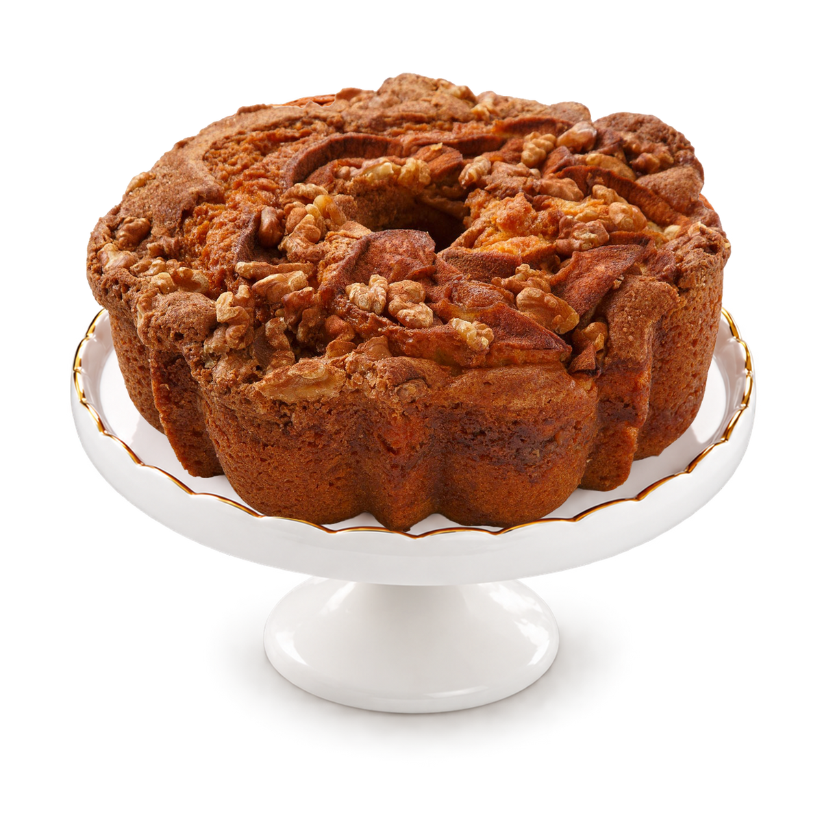 A freshly baked apple cinnamon bundt cake with walnuts and pecans on top, presented on a white ceramic cake stand with a gold-trimmed rim.