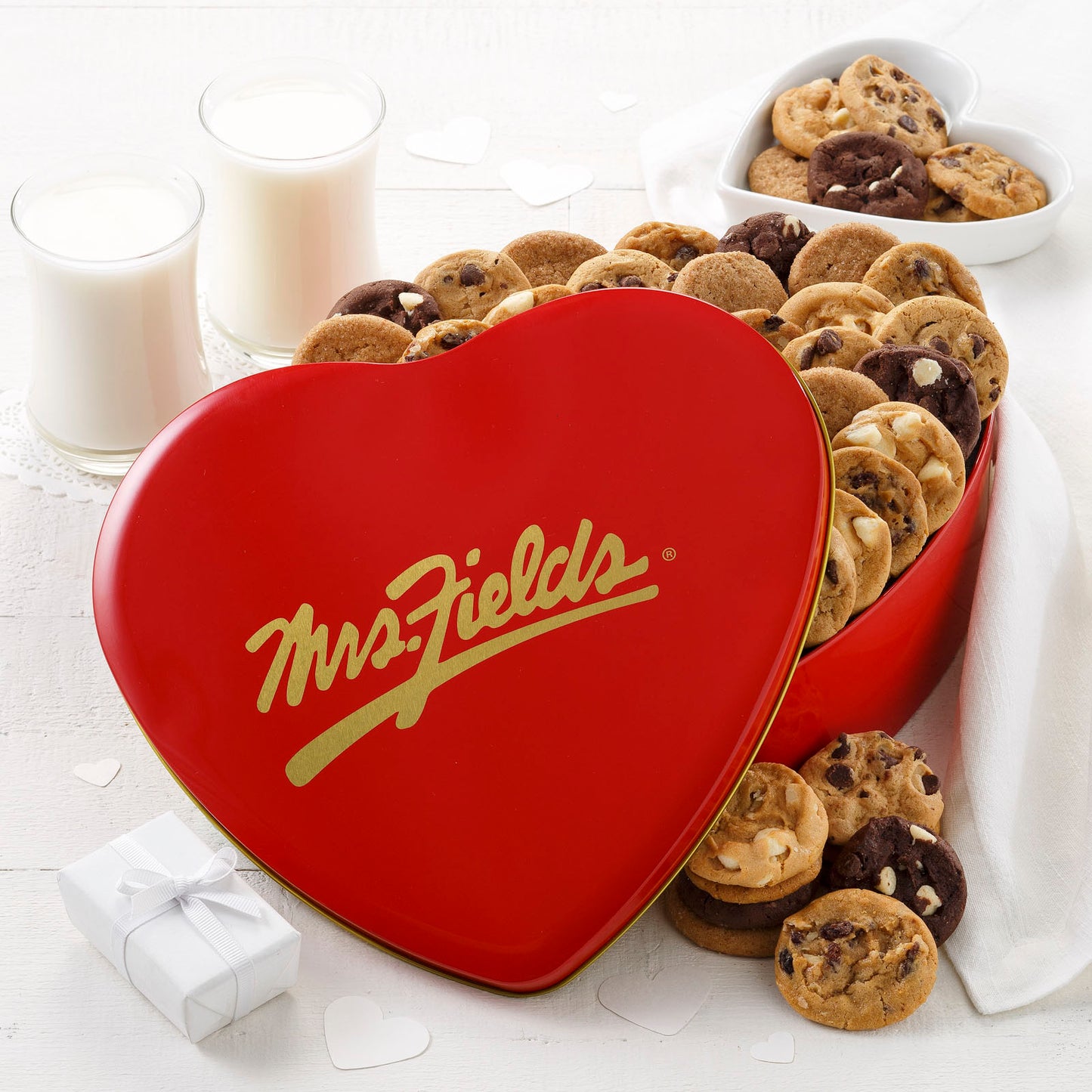 A heart shaped Mrs Fields red and gold gift tin filled with an assortment of Nibblers